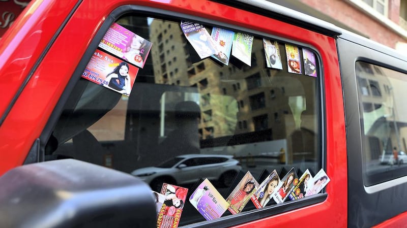 Massage cards are often placed on vehicles around city centres. Pawan Singh / The National