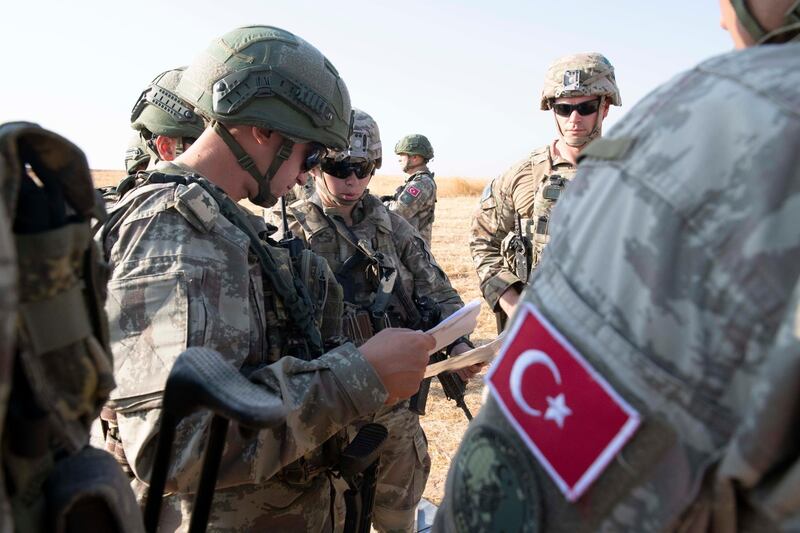 A handout photo made available by the US Army shows US and Turkish military forces conducting the third ground combined joint patrol inside the security mechanism area in northeast Syria. US troops began withdrawing ahead of a Turkish operation in north-east Syria.  EPA