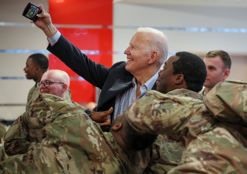 Mr Biden takes a selfie with US soldiers near Rzeszow. Reuters