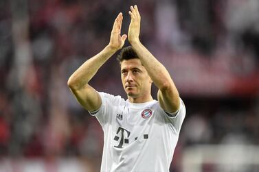 FILE - In this Sunday, Feb. 16, 2020 file photo, Bayern's Robert Lewandowski celebrates with supporters after winning their German Bundesliga soccer match against 1. FC Cologne in Cologne, Germany. The coronavirus pandemic has changed almost everything about soccer in Germany, except Bayern Munich's chances of winning. When the Bundesliga resumes on Saturday, May 16 after a two-month suspension caused by the pandemic, Borussia Dortmund and Leipzig will be Bayern's main challengers. Bayern’s Robert Lewandowski, Borussia Dortmund’s Erling Haaland and Leipzig’s Timo Werner have all been crucial to their team's challenges with explosive scoring form. (AP Photo/Martin Meissner, file)