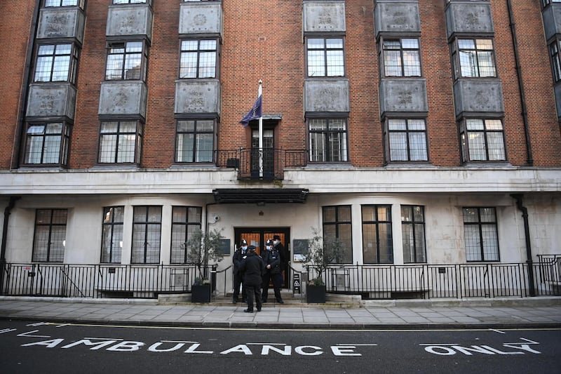 Police officers stand at an entrance of the King Edward VII hospital. EPA