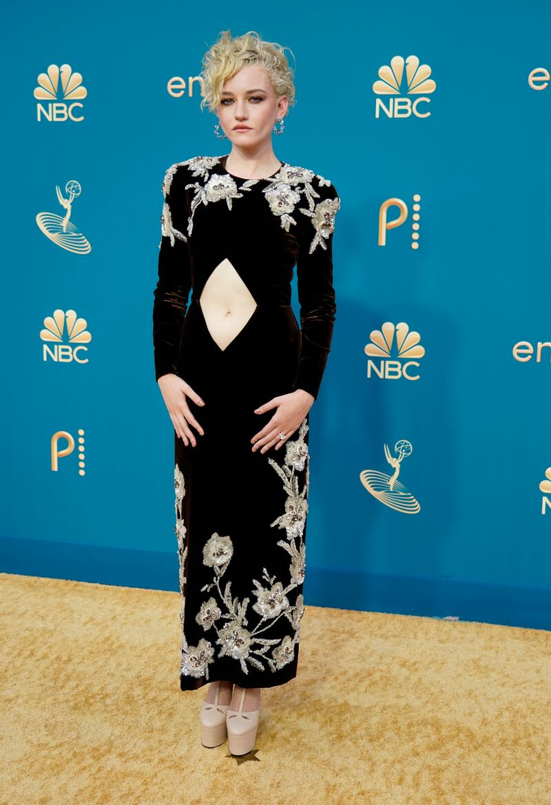 Julia Garner wears a velvet Gucci gown with floral sequinned detail. AP Photo