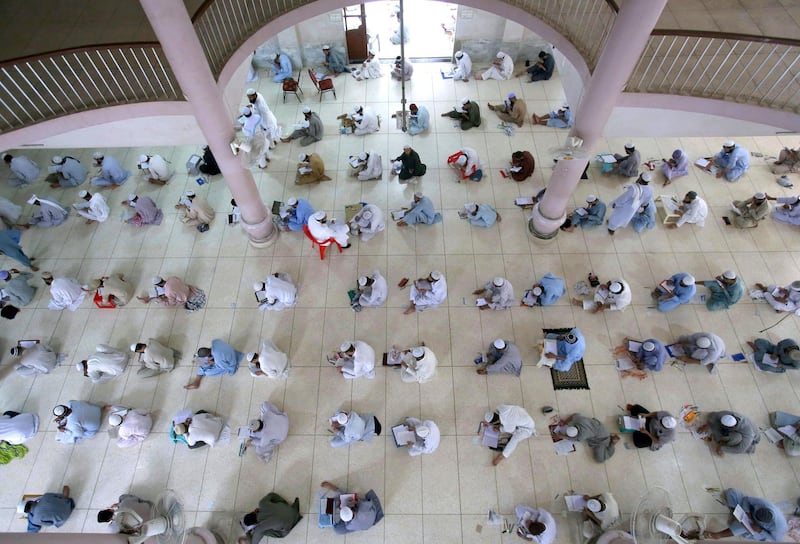 Muslim students from Pakistan and abroad take an examination at Jamia Binoria, country's one of the largest Islamic seminary, in Karachi, Pakistan. Fareed Khan / AP Photo
