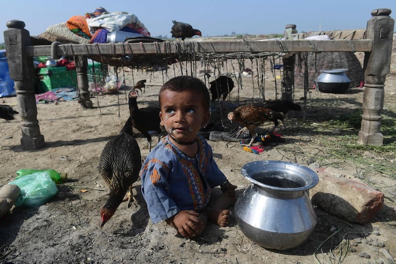 A child sits on a dry ground at a makeshift camp in Shikarpur. AFP