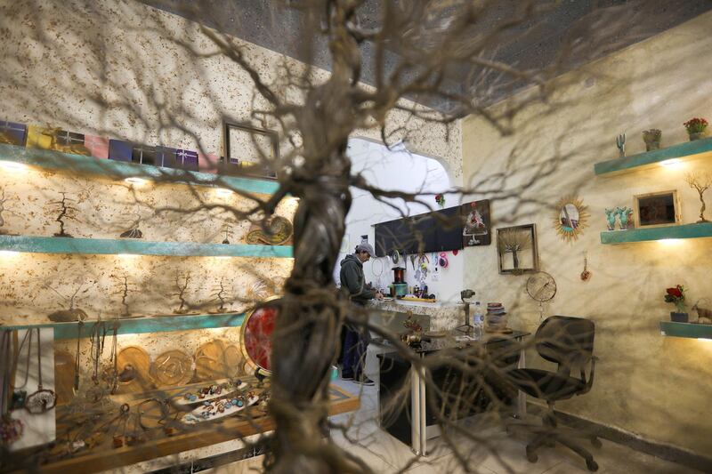 Ahmad Al Jundi creates a miniature tree, made entirely out of wire at his store in Amman, Jordan. Reuters