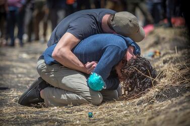 Relatives react at the scene where the Ethiopian Airlines Boeing 737 Max 8 crashed shortly after takeoff on Sunday killing all 157 on board. AP