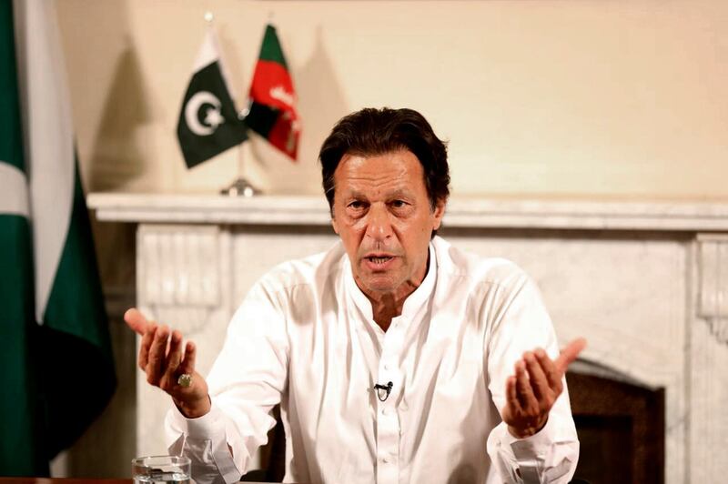 In this photo provided by the office of Pakistan Tehreek-e-Insaf party, Pakistani politician Imran Khan, chief of Pakistan Tehreek-e-Insaf party, delivers his address in Islamabad, Pakistan, Thursday, July 26, 2018. Khan declared victory Thursday for his party in the country's general elections, promising a "new" Pakistan following a vote that was marred by allegations of fraud and militant violence. (Tehreek-e-Insaf via AP)