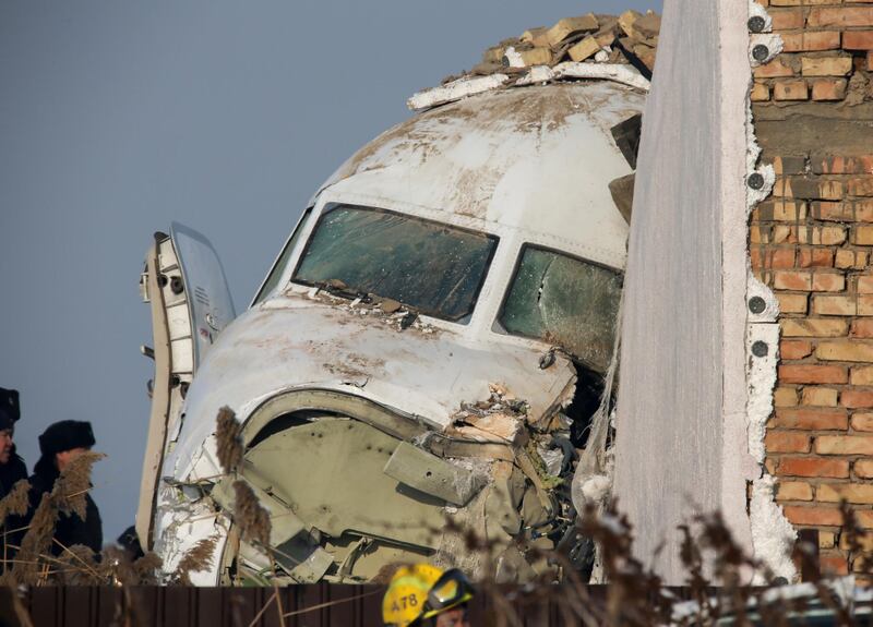 Emergency and security personnel are seen at the site of the plane crash near Almaty, Kazakhstan. Reuters