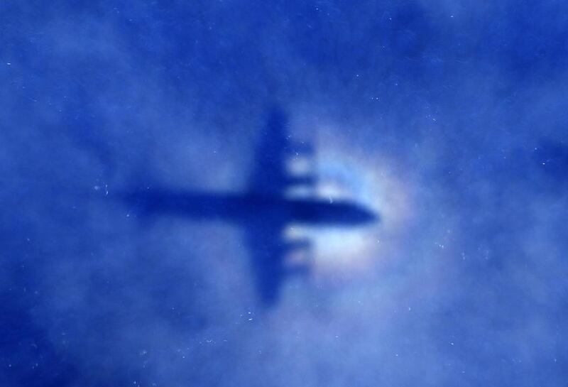 The shadow of a Royal New Zealand Air Force P3 Orion maritime search aircraft is seen on low-level clouds as it flies over the southern Indian Ocean looking for missing Malaysian Airlines flight MH370 in this March 31 file photo. Rob Griffith/Reuters