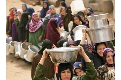 Egyptian women wait in line to fill their containers with clean water northeast of Cairo. AFP