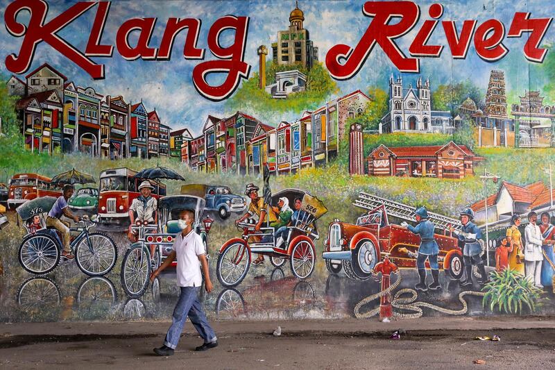 A man wears face mask as he walks past the Klang river mural in Klang, Malaysia. Klang district in state of Selangor is within the red zone area under the Conditional Movement Control Order (CMCO) after increasing numbers of cases of COVID-19 disease.  EPA