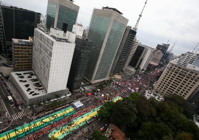 Demonstrators gather holding signs and banners against President Jair Bolsonaro in Sao Paulo, Brazil. Getty.