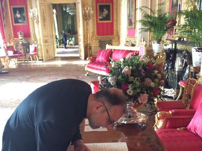 'It was a really, really lovely experience,' says Father Nadim, pictured signing the register at Windsor Castle. Photo: Nadim Nassar