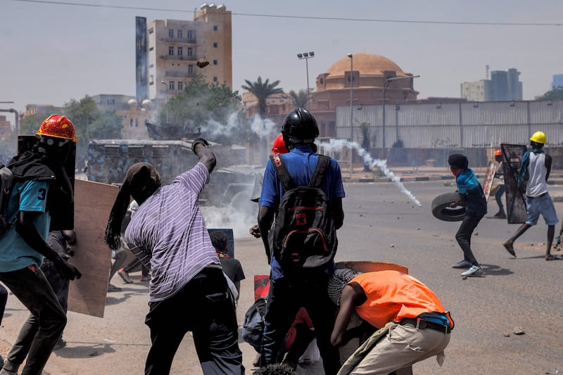 Tear gas canisters fly amid clashes in central Khartoum. AFP
