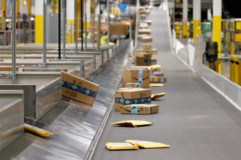 FILE - In this Dec. 17, 2019, file photo Amazon packages move along a conveyor at an Amazon warehouse facility in Goodyear, Ariz. (AP Photo/Ross D. Franklin, File)