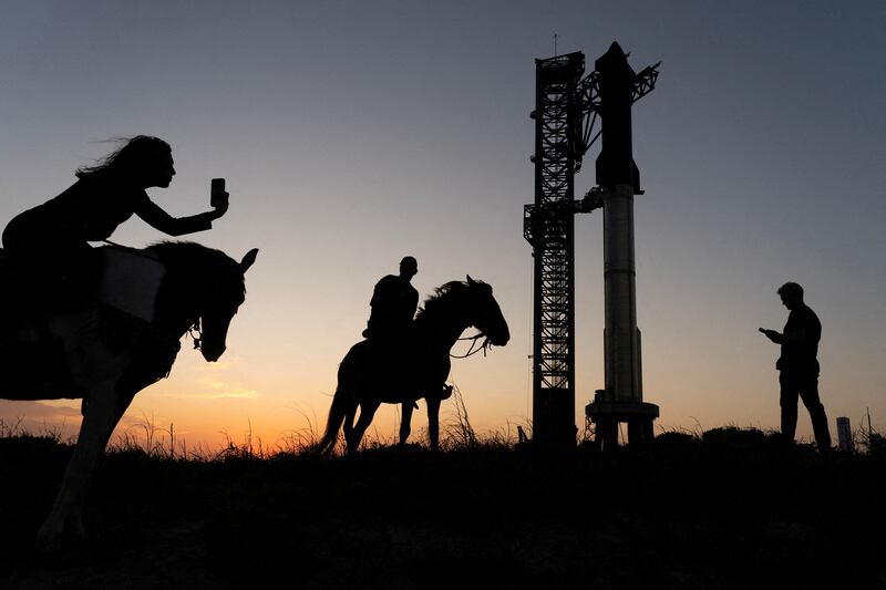 People on horseback photograph the SpaceX Starship on its Boca Chica launch pad near Brownsville. Reuters