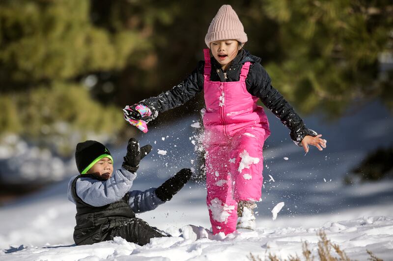 Jedrick Basutista, 5, left, and Janelle Cabrillos, 7, play in the snow along Table Mountain Road in Wrightwood, California. All photos: Getty Images