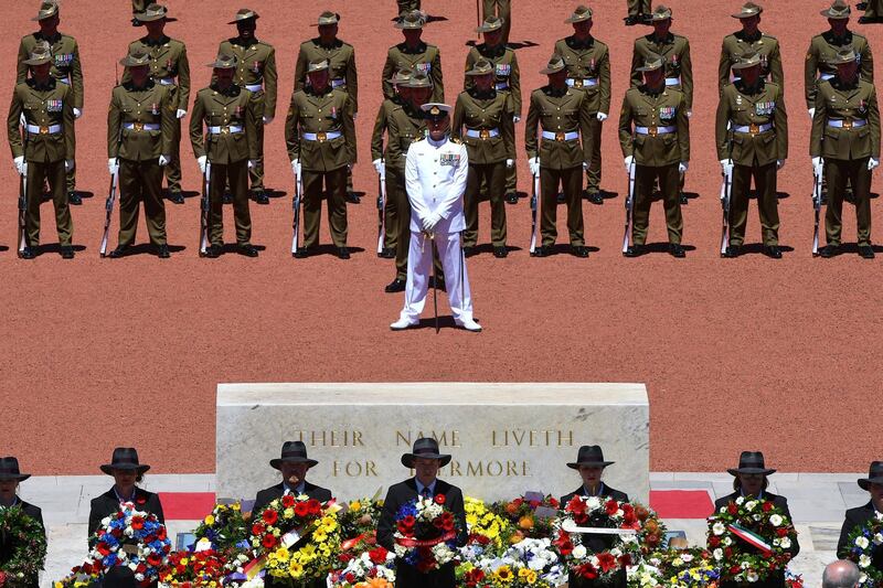 Members of Australia's armed forces stand behind officials holding wreaths during a memorial service at the Australian War Memorial in Canberra. Reuters