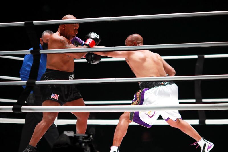 Mike Tyson attempts to block a punch thrown by Roy Jones, Jr. Reuters