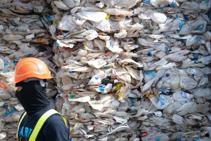 FILE - In this Tuesday, May 28, 2019, file photo, a container is filled with plastic waste from Australia, in Port Klang, Malaysia. The practice of advanced countries such as the U.S., Canada and Japan sending their non-recyclable waste to poorer countries is "grossly unfair" and should stop, Malaysian Prime Minister Mahathir Mohamad said in Tokyo Thursday, May 30, 2019. His comments came days after his government announced plans to return thousands of tons of imported plastic waste back to where it came from. (AP Photo/Vincent Thian, File)