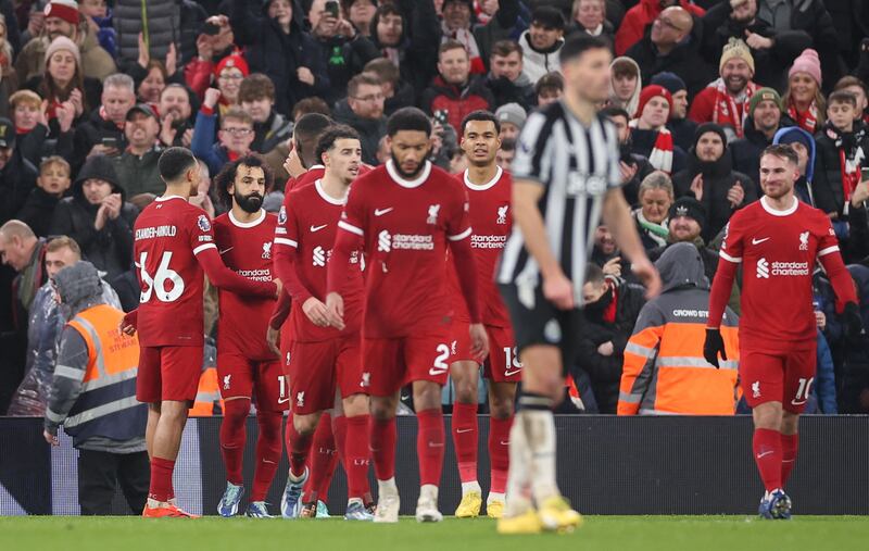 Mohamed Salah celebrates with Liverpool teammates after scoring the penalty to make it 4-2. EPA