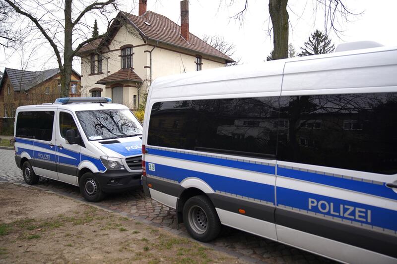 epa08305861 Police cars stand in front of a house during ongoing searchings at a house in the south of Berlin, Germany, 19 March 2020. German Minister of Interior, Construction and Homeland Horst Seehofer banned for the first time a group of the Reich Citizens' Association (Reichsbuergervereinigung) called United German peoples and tribes (Geeinte deutsche Voelker und Staemme)  EPA/CLEMENS BILAN
