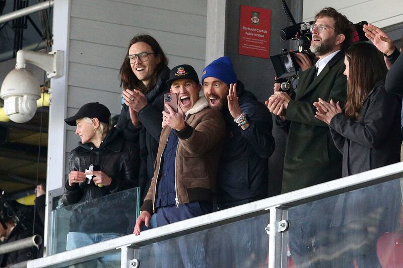 Wrexham owners Ryan Reynolds, centre right, and Rob McElhenney, centre left, react during the National League match between Wrexham against Notts County. PA via