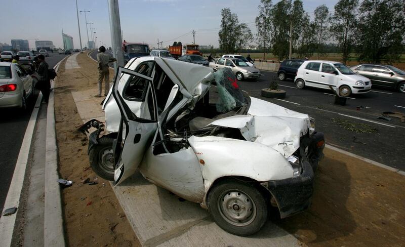 A crushed Maruti Zen car lies on the divider of the expressway in Gurgaon, a suburb south of New Delhi, on March 14, 2007. Gurinder Osan/AP Photo