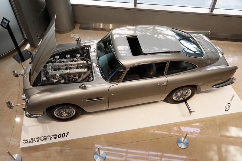 A James Bond 1965 Aston Martin DB5 is displayed at Sotheby's, in New York, Monday, July 29, 2019. The car is one of just three surviving original examples commissioned, and fitted with MI6 Q specifications. It is estimated at $4 million - $6 million when offered at sale in Monterey, Calif, Aug. 15. (AP Photo/Richard Drew)