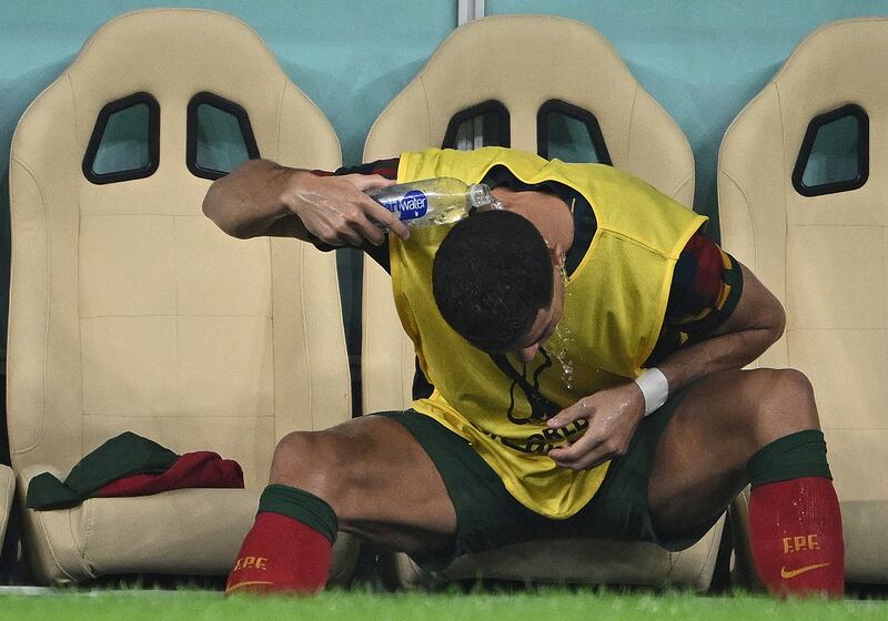 Cristiano Ronaldo pours water on his head. AFP