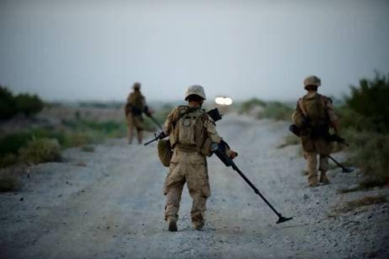 US marines use metal detectors to find improvised explosive devices (IEDs) in Afghanistan's Helmand province. Manpreet Romana / AFP