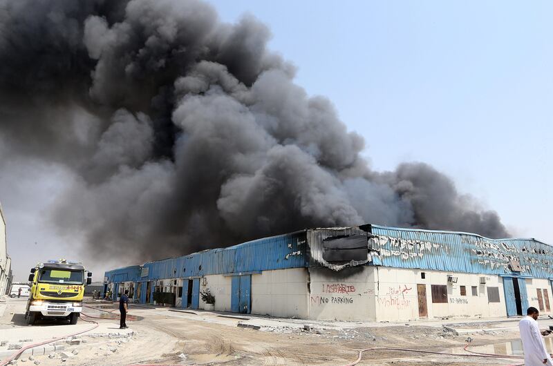 SHARJAH , UNITED ARAB EMIRATES - JUNE 26 : Major fire broke out in the warehouse area in Sharjah Industrial area close to the National Paints in Sharjah. Civil Defense personals trying to control the fire.  ( Pawan Singh / The National ) For News. Story by Nawal Al Ramahi