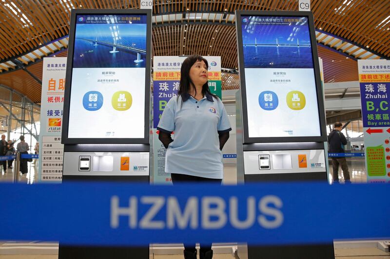 A staff member stands next to the ticket machines in Hong Kong. AP Photo