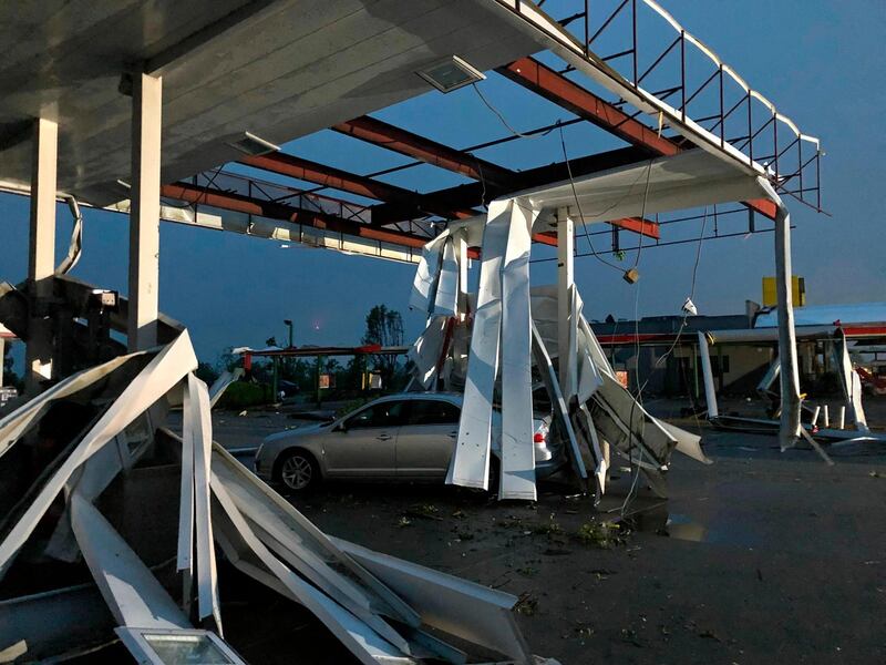 A car is trapped under the fallen metal roof of the Break Time petrol station in Jefferson City. AP Photo