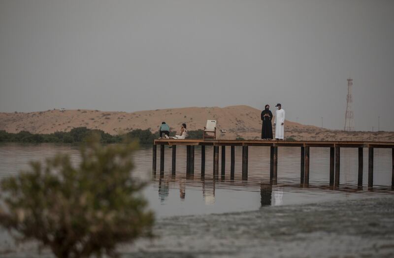 Visitors walk along the boardwalk at Umm Al Quwain's coolest beachside hangout
