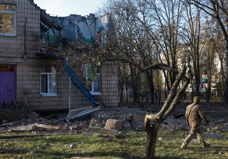 A police officer inspects a kindergarten damaged during the strikes in Kyiv. EPA