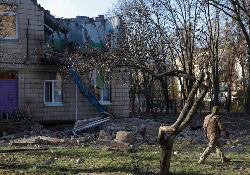 A police officer inspects a kindergarten damaged during the strikes in Kyiv. EPA