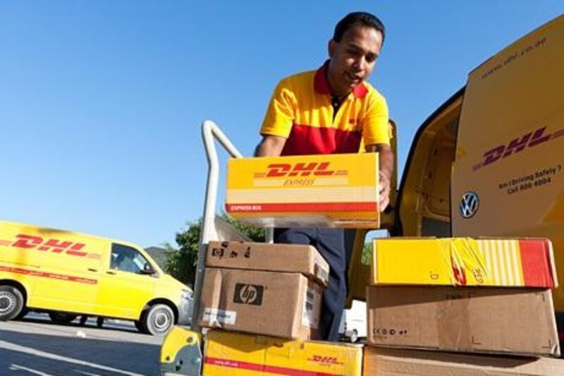  Loading his van, DHL courier Janaka Chaminda prepares for his morning shift delivering parcels to the Lamcy area of Dubai.  Duncan Chard for the National?