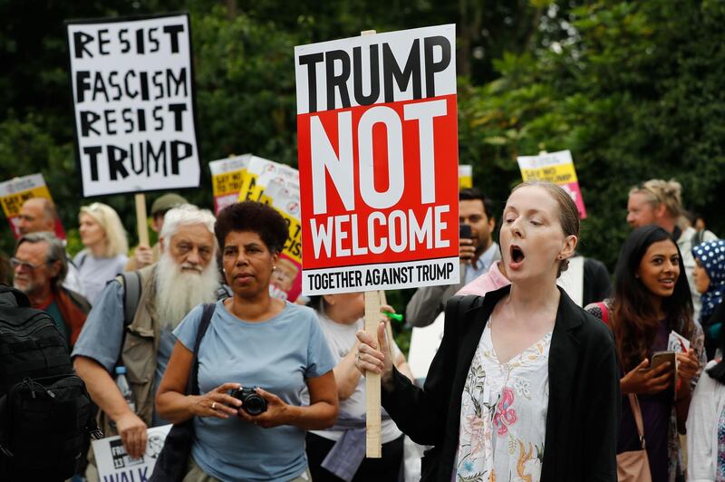 Protesters against the visit of US President Donald Trump gather near an entrance to the US ambassador's residence Winfield House in Regents Park in London on July 12, 2018. AFP