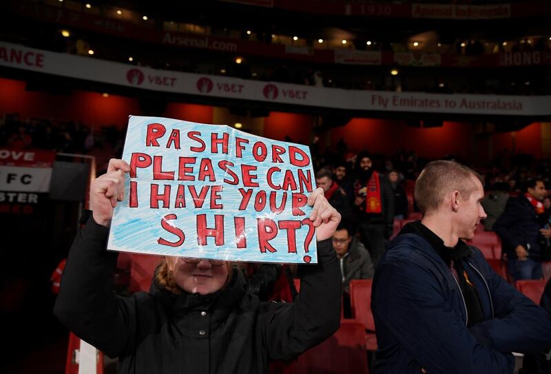A fan holds up a sign in reference to Manchester United's Marcus Rashford inside the Emirates Sstadium before the match against Arsenal on January 1, 2020. Reuters