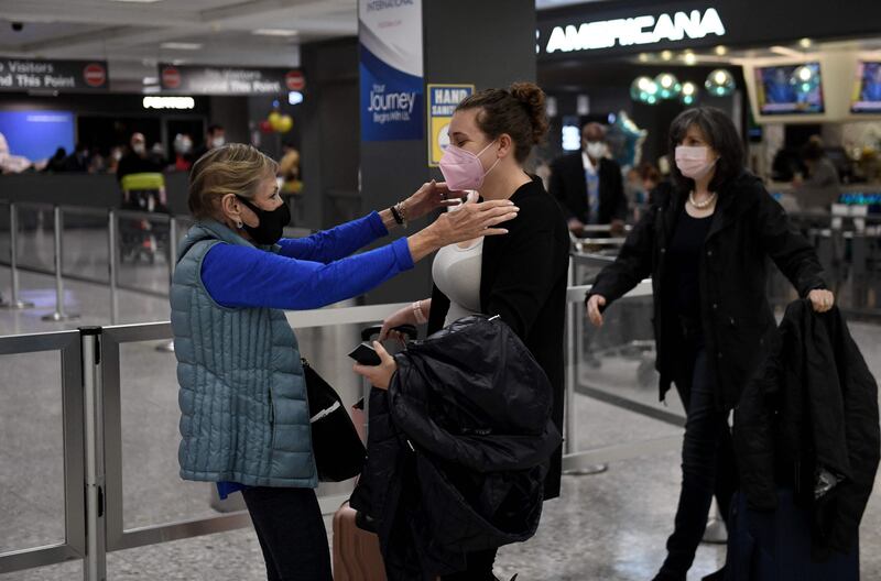 Family members embrace as they are reunited at Dulles International Airport. AFP