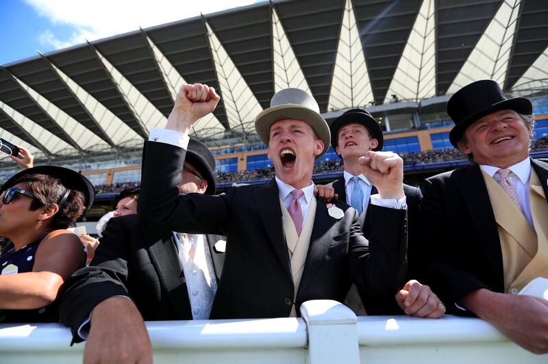 Racegoers enjoy the action. Mike Egerton / PA Wire