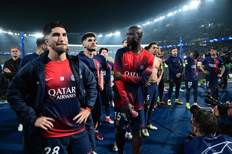 Achraf Hakimi and his PSG teammates face the fans after defeat to Dortmund. AFP