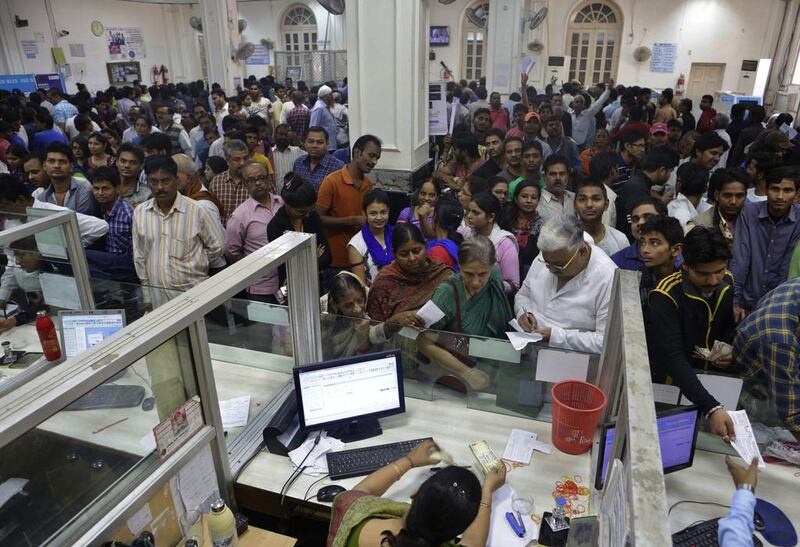 People crowd inside a bank to deposit and exchange discontinued currency notes in Allahabad, India, on November 12, 2016. Rajesh Kumar Singh / AP Photo