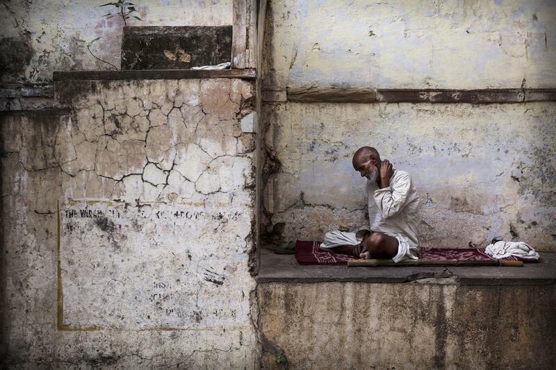 An Indian Hindu man sits in an alleyway in Varanasi, India. Indians will vote in the ninth and final phase of a general election Monday that includes the holy city of Varanasi. Kevin Frayer / Getty