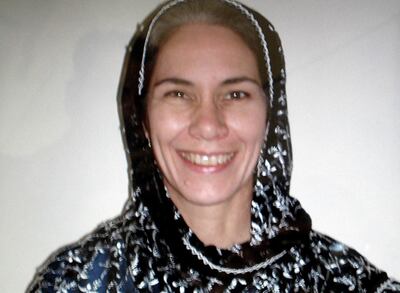 This picture taken, 27 January 2008 from photo in her office shows US aid worker Cyd Mizell, 49, posing for a photograph in her office in Kandahar. Police in Afghanistan's southern city of Kandahar were hunting on 27 January for the abductors of a US aid worker and her driver as the Taliban militia said it could not "yet" take responsibility. There was a heavier-than-usual police presence in the area where Cyd Mizell, 49, and her Afghan driver were seized while travelling to work on 26 January and police were searching every vehicle, an AFP reporter said. AFP PHOTO/Hamid  Zalmy (Photo by HAMID ZALMY / AFP)