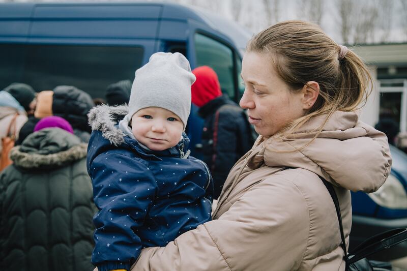 Tatiana and her son wait for a van that will carry them from the Moldovan border to Chisinau. Erin Clare Brown for The National