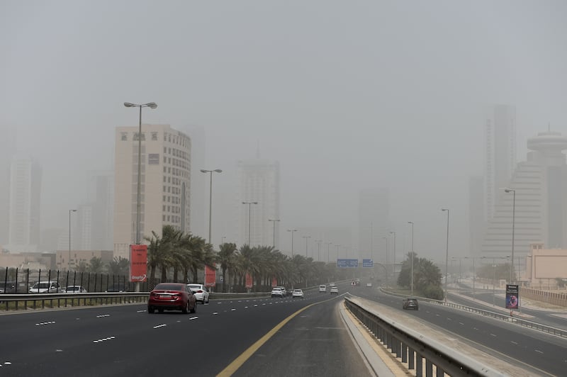 Heavy dust reduces visibility on a road in Manama. AFP