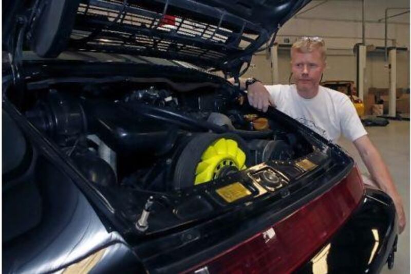 Graham Henderson with his reinvigorated Porsche 911, at House of Cars Garage. Jeffrey E Biteng / The National