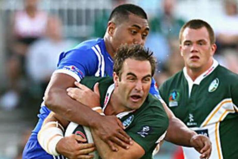 Ryan Tandy of Ireland is tackled during the 2008 Rugby League World Cup Pool 3 match between Ireland and Samoa.